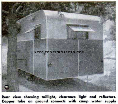 Rear view of a travel trailer showing the brake, running and clearance lights.